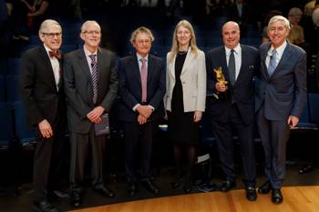 Scientists from The Rockefeller University pose with SNF Co-President Andreas Dracopoulos, who holds a helix-shaped award.